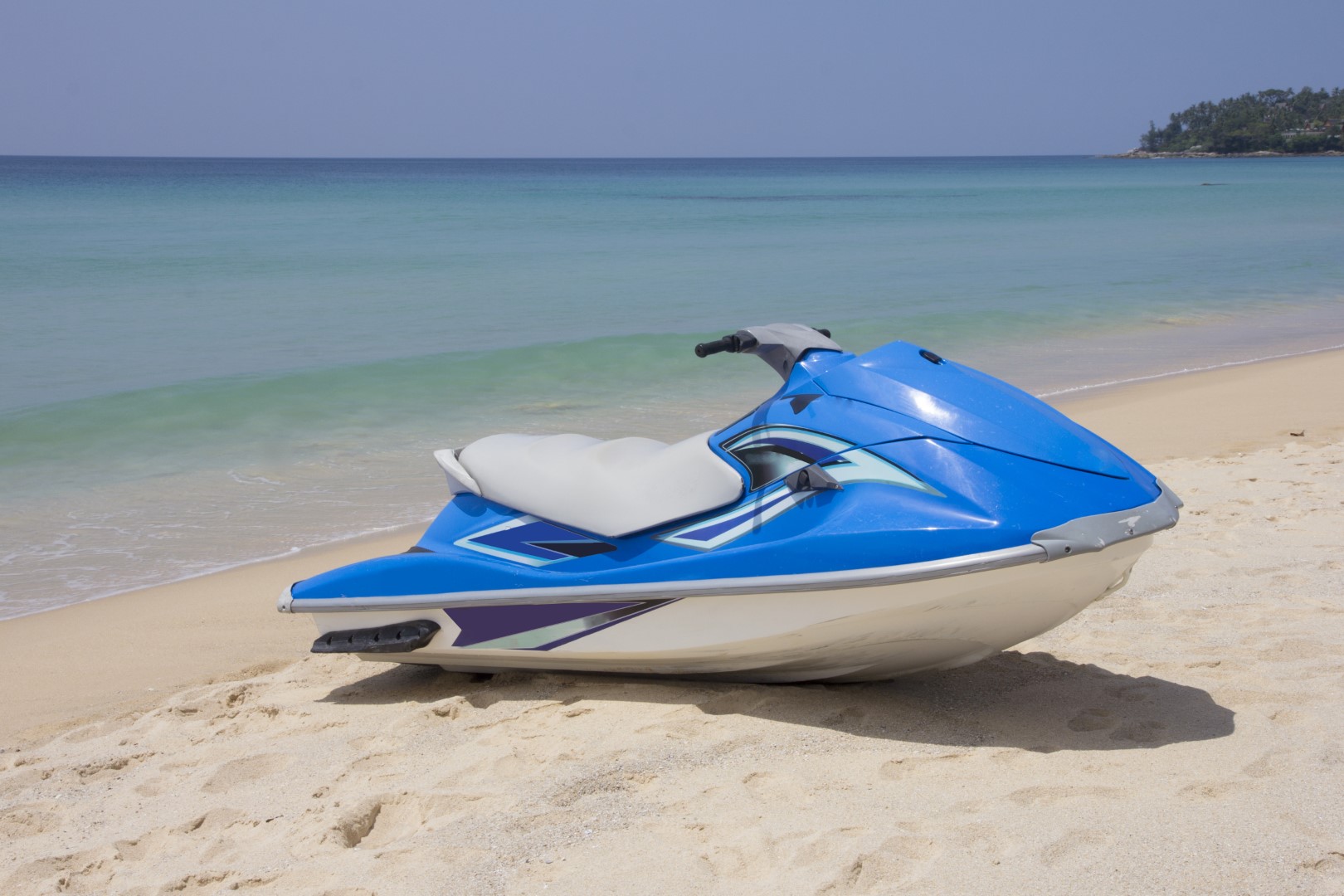 stock-photo-blue-jetski-on-sandy-beach-surin-phuket-thailand-image-by-kevin-hellon-228456781
